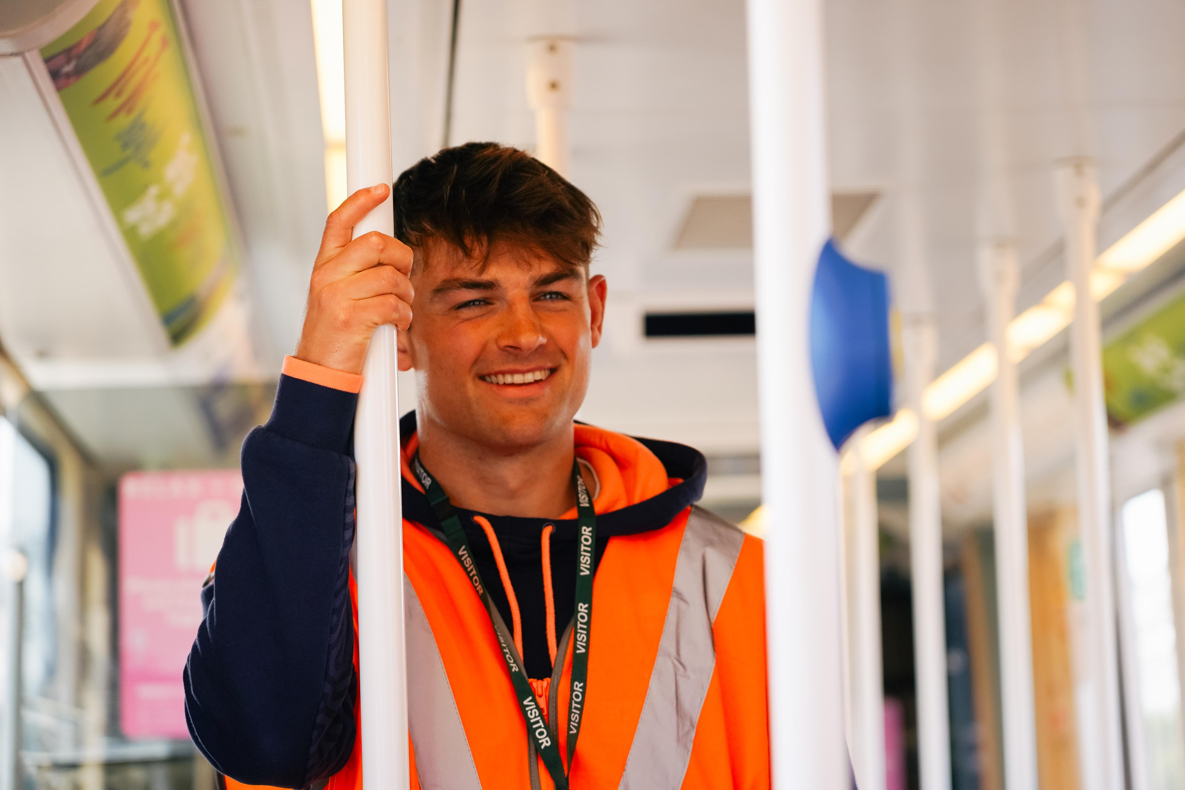 An image of player Ross Thompson on a tram