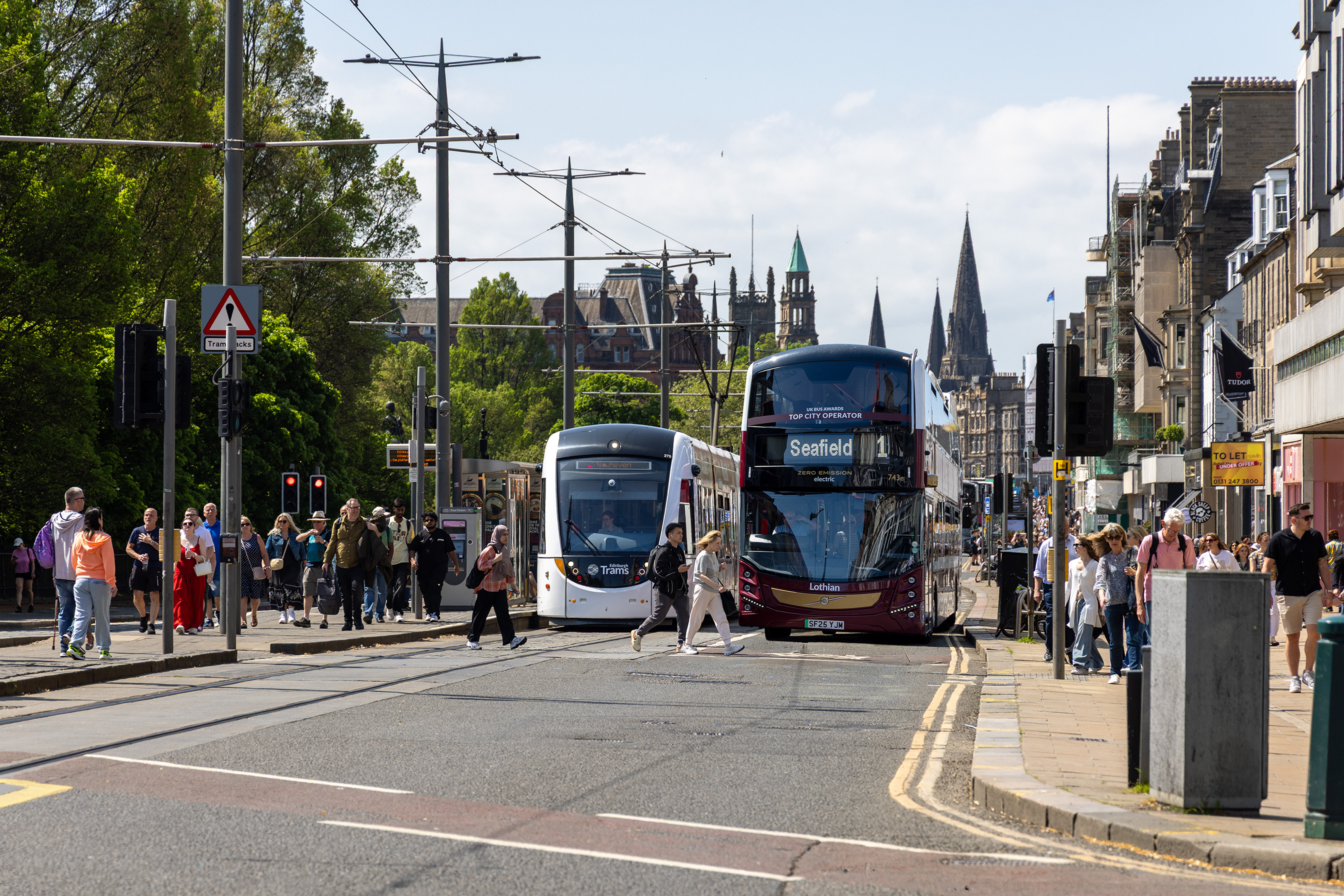 An image of a bus and tram on Princes Street