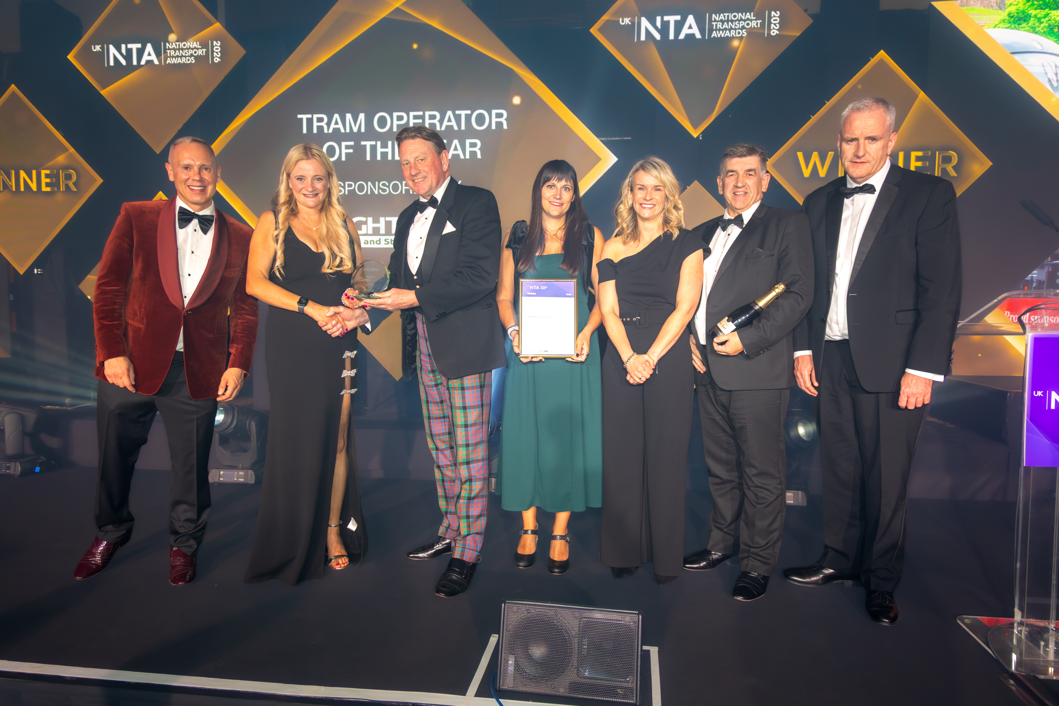Edinburgh Trams colleagues on stage accepting an award at the National Transport Awards