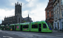 an image of the green 'Tap on, Tap off' tram in Edinburgh city centre, with 'coming soon' message applied.