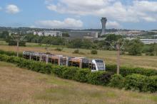 Edinburgh Trams tram with Edinburgh Airport in the background