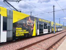 an image of a tram in the depot, with EIF branding on it