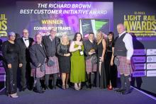 Members of the Edinburgh Trams team standing on stage accepting award
