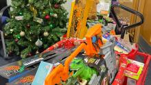 Box of toys in front of Christmas tree in Edinburgh Trams depot