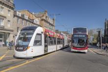 An image of a bus and tram on Princes Street
