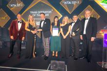 Edinburgh Trams colleagues on stage accepting an award at the National Transport Awards