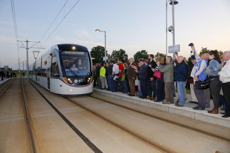 a tram approaches a busy Gyle Centre stop
