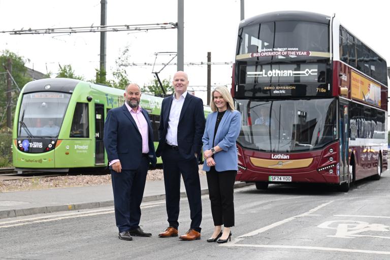 Lea Harrison, Dave Thompson and Sarah Boyd with the bus and tram