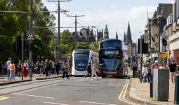 An image of a bus and tram on Princes Street
