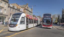 An image of a bus and tram on Princes Street