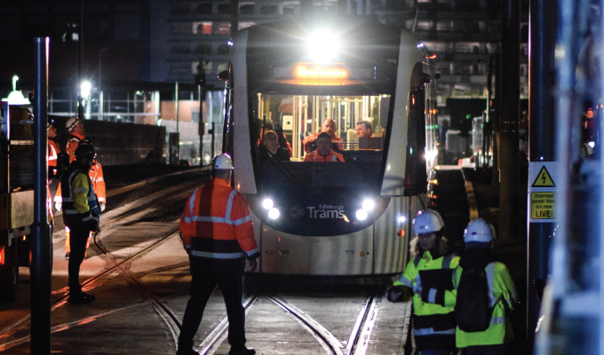 Trams to Newhaven testing team in front of tram at night