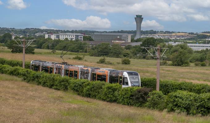Edinburgh Trams tram with Edinburgh Airport in the background