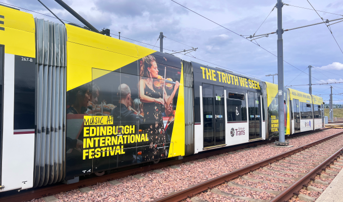an image of a tram in the depot, with EIF branding on it