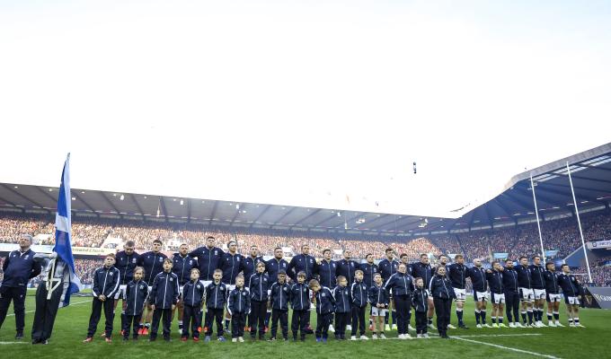 Scotland team with the Child Mascots on game day at Murrayfield Stadium