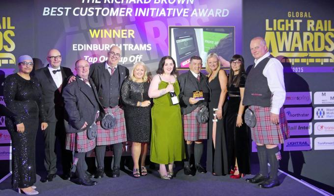 Members of the Edinburgh Trams team standing on stage accepting award