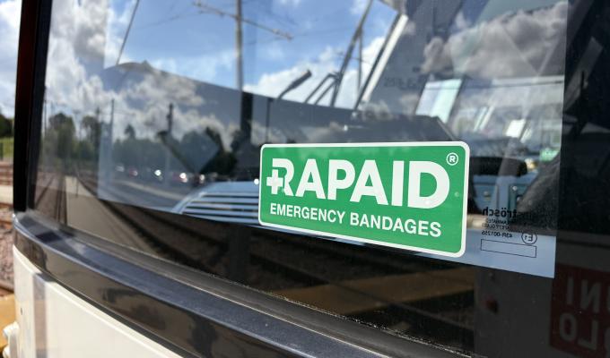 An image of the RAPAID logo on a green sticker in the window of a tram cab.