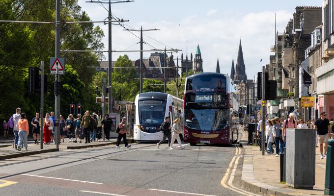An image of a bus and tram on Princes Street