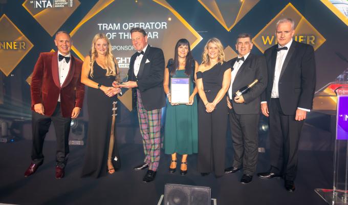 Edinburgh Trams colleagues on stage accepting an award at the National Transport Awards